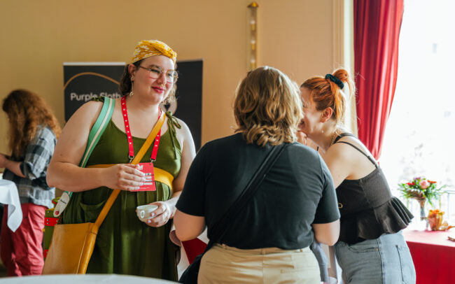Photo of attendees talking to each other at Womenize 2025