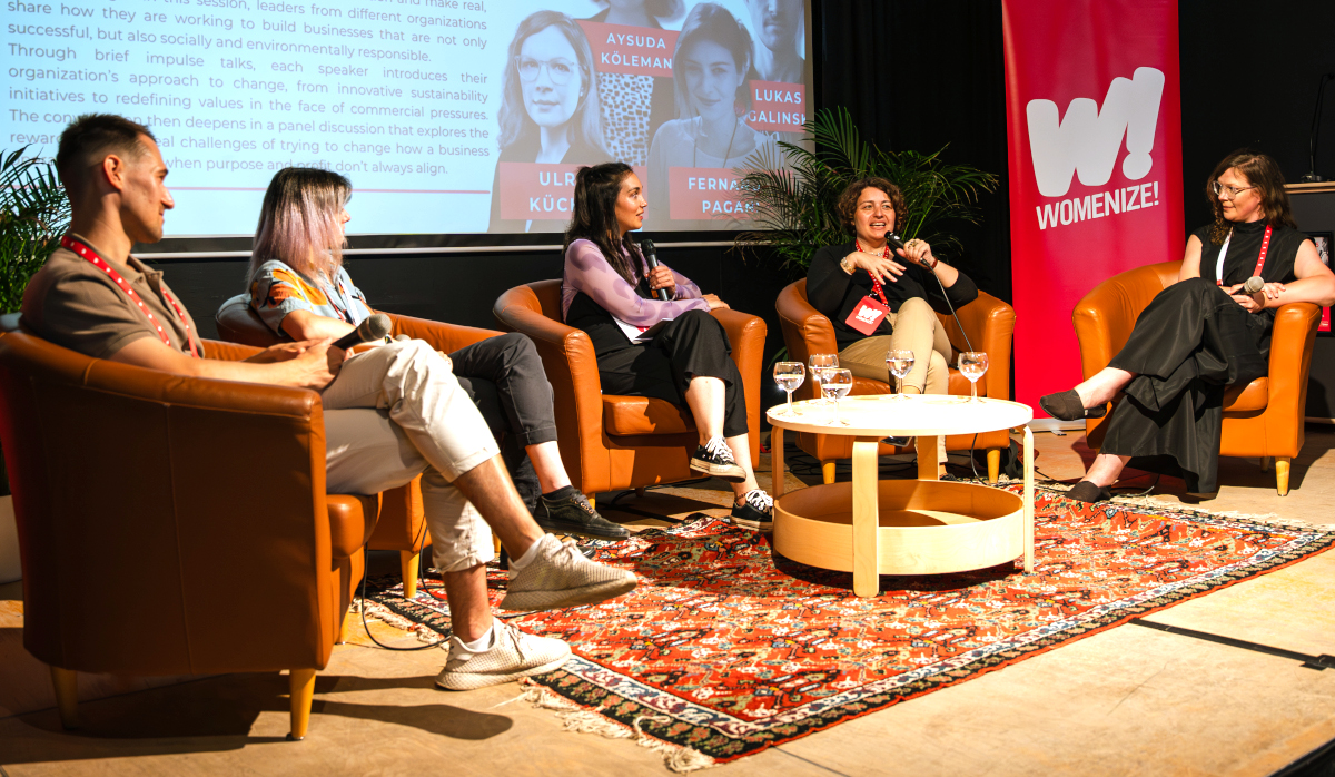 Speakers on stage at a Womenize panel