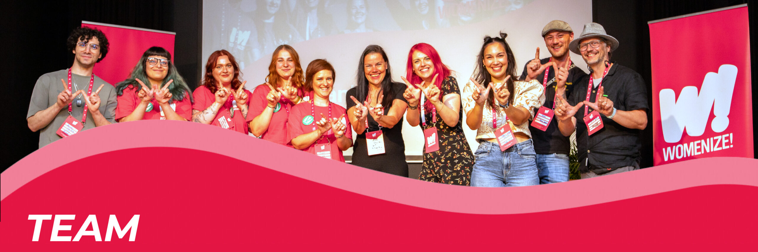 Header image for the team page, showing the Womenize team and volunteers on our stage