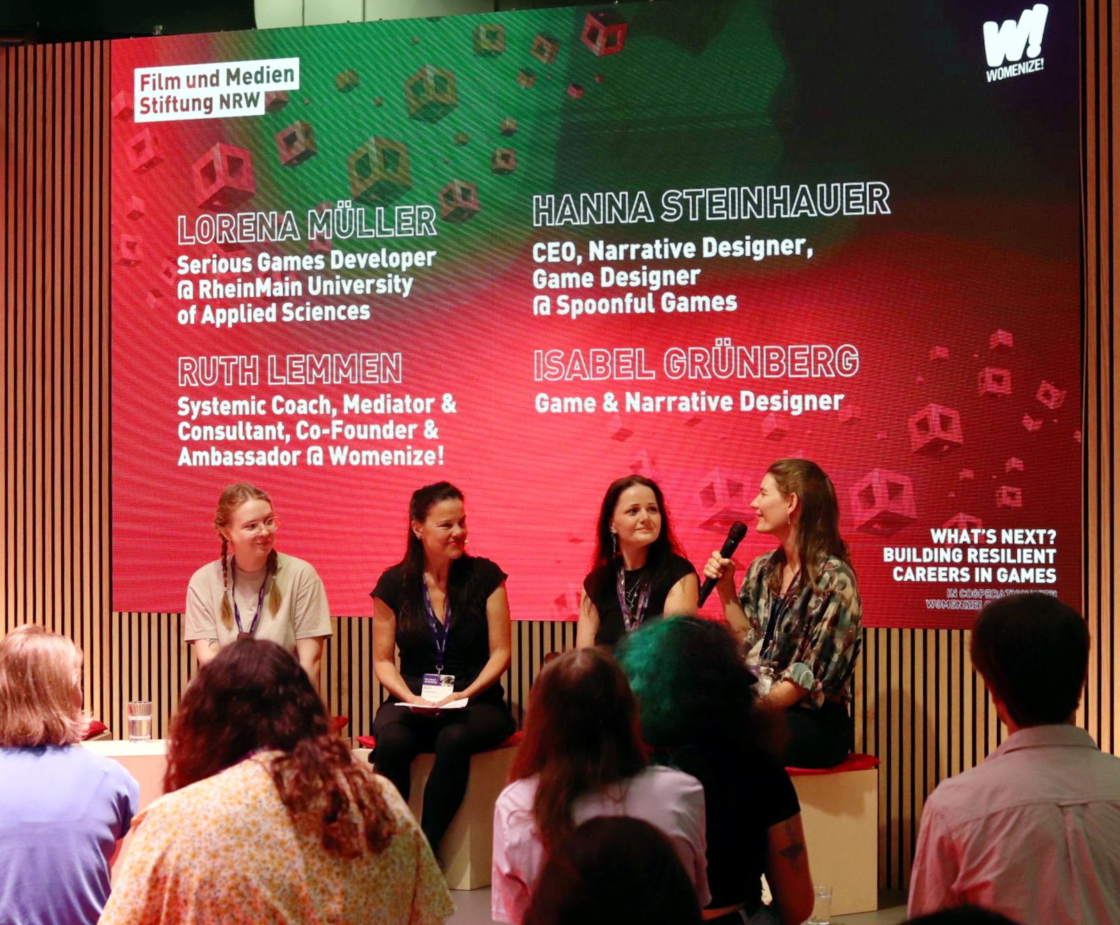 panel Ruth Lemmen hosting a Womenize! panel at the gamescom booth of the Film- und Medienstiftung NRW